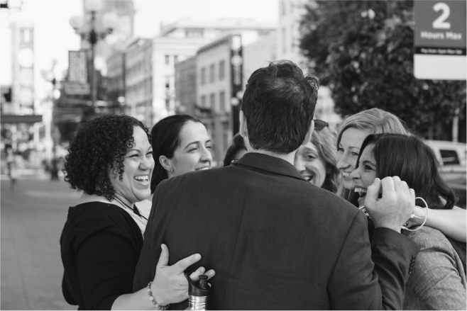 Impact Hub professionals and entrepreneurs hugging, black and white image